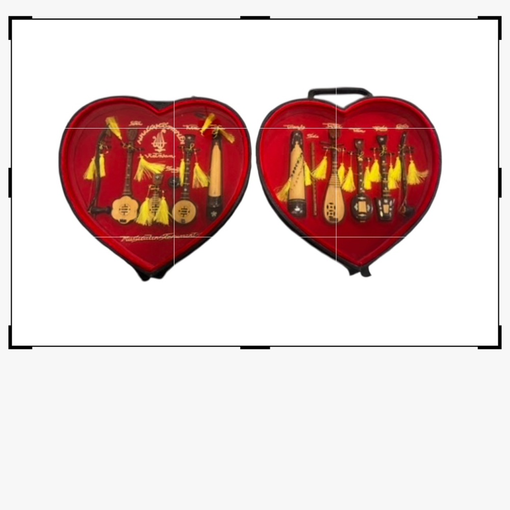 Vietnamese musical mini wooden instruments in a heart shape shadow box.